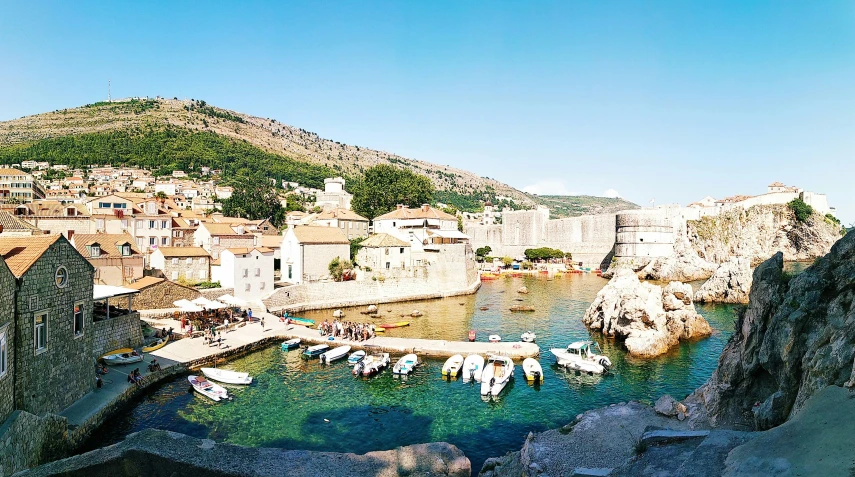 small boats are parked at a harbor near buildings