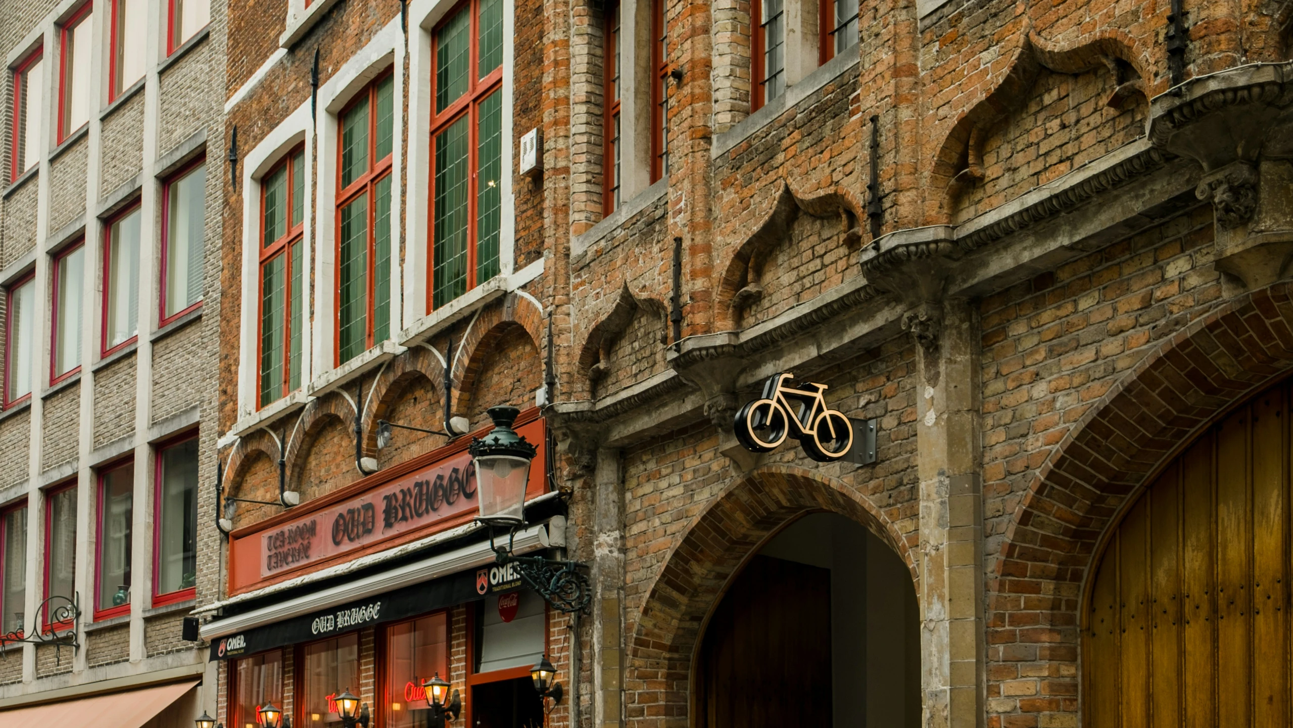 there is an image of a building with an entrance and bicycle shop sign