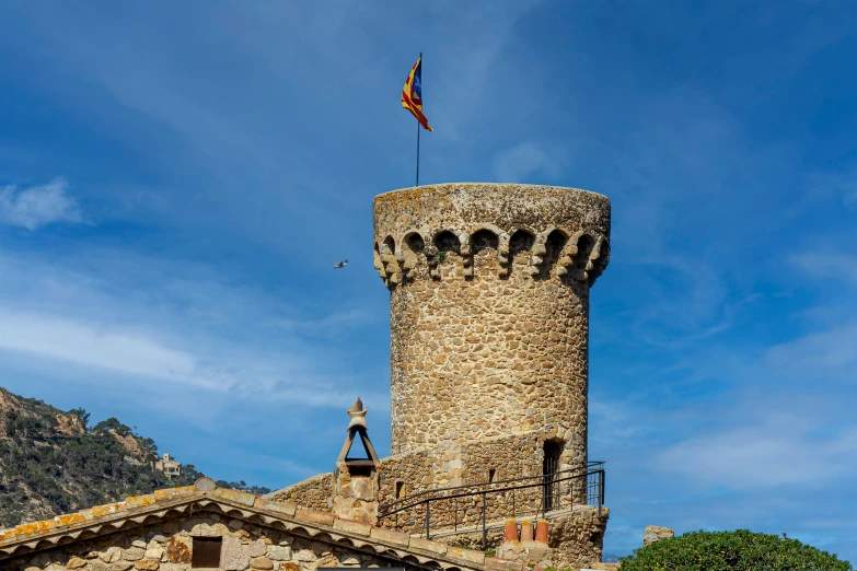 a tall castle with a tall flag on top