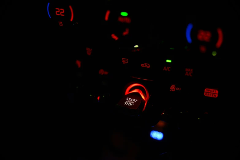 the dashboard of a vehicle with illuminated lights at night