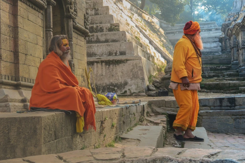 a couple of men sitting on the steps