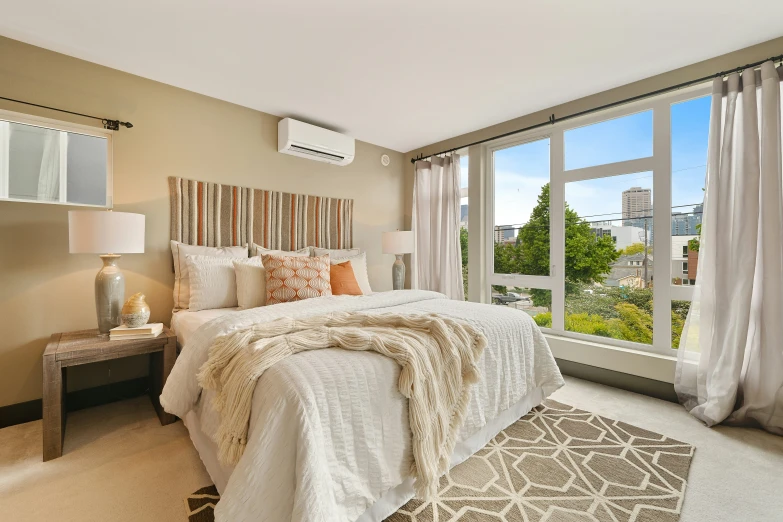 a bedroom with a king bed and lots of windows