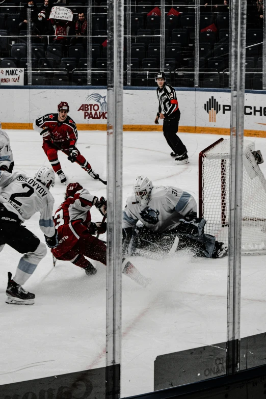 a hockey game with one goalie watching the opposing team play