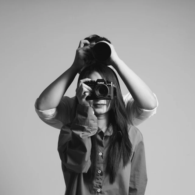 a girl with sunglasses covering her eyes and looking through binoculars