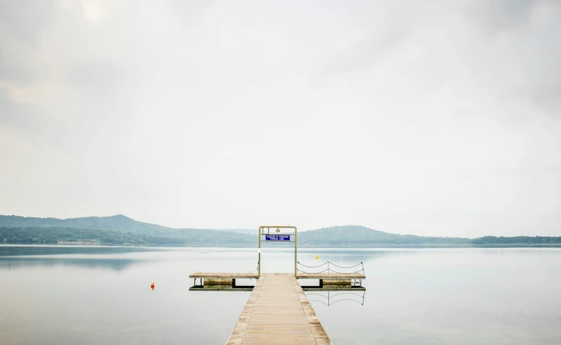 a long dock sitting in the middle of a large body of water