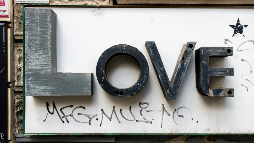 the letters love and magnamie are etched in graffiti