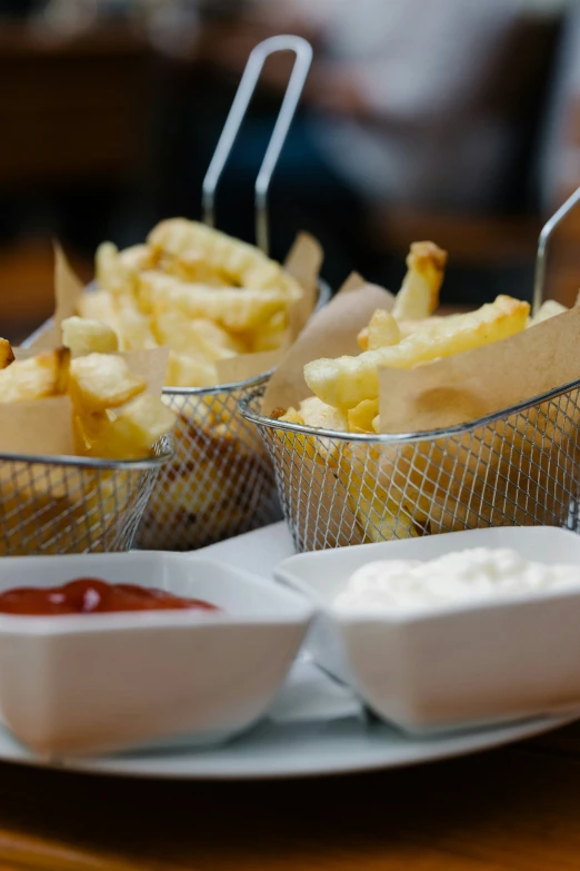 fries are on plates, with ketchup and mustard