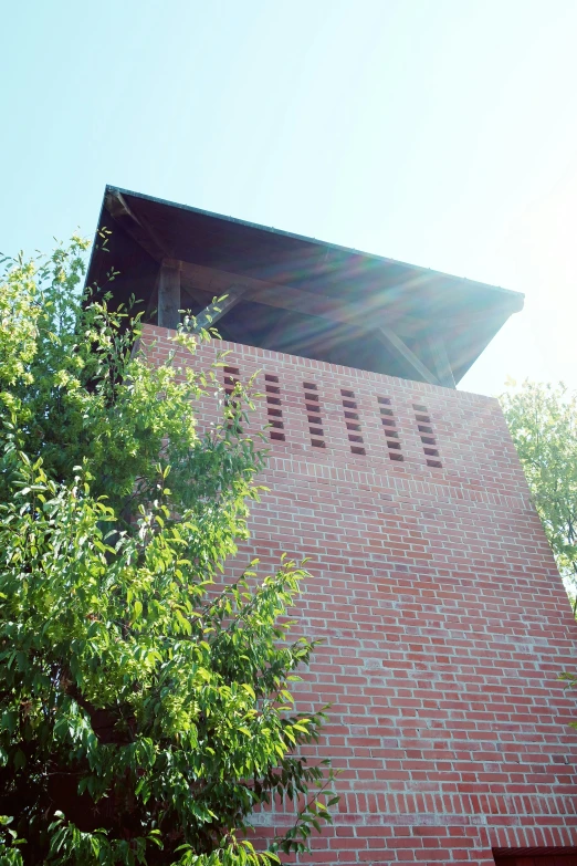 a large brick building with trees around it