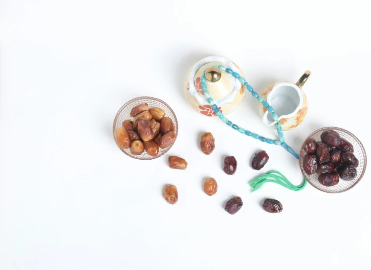 nuts are sitting on the counter with a tea cup, spoon and some other items