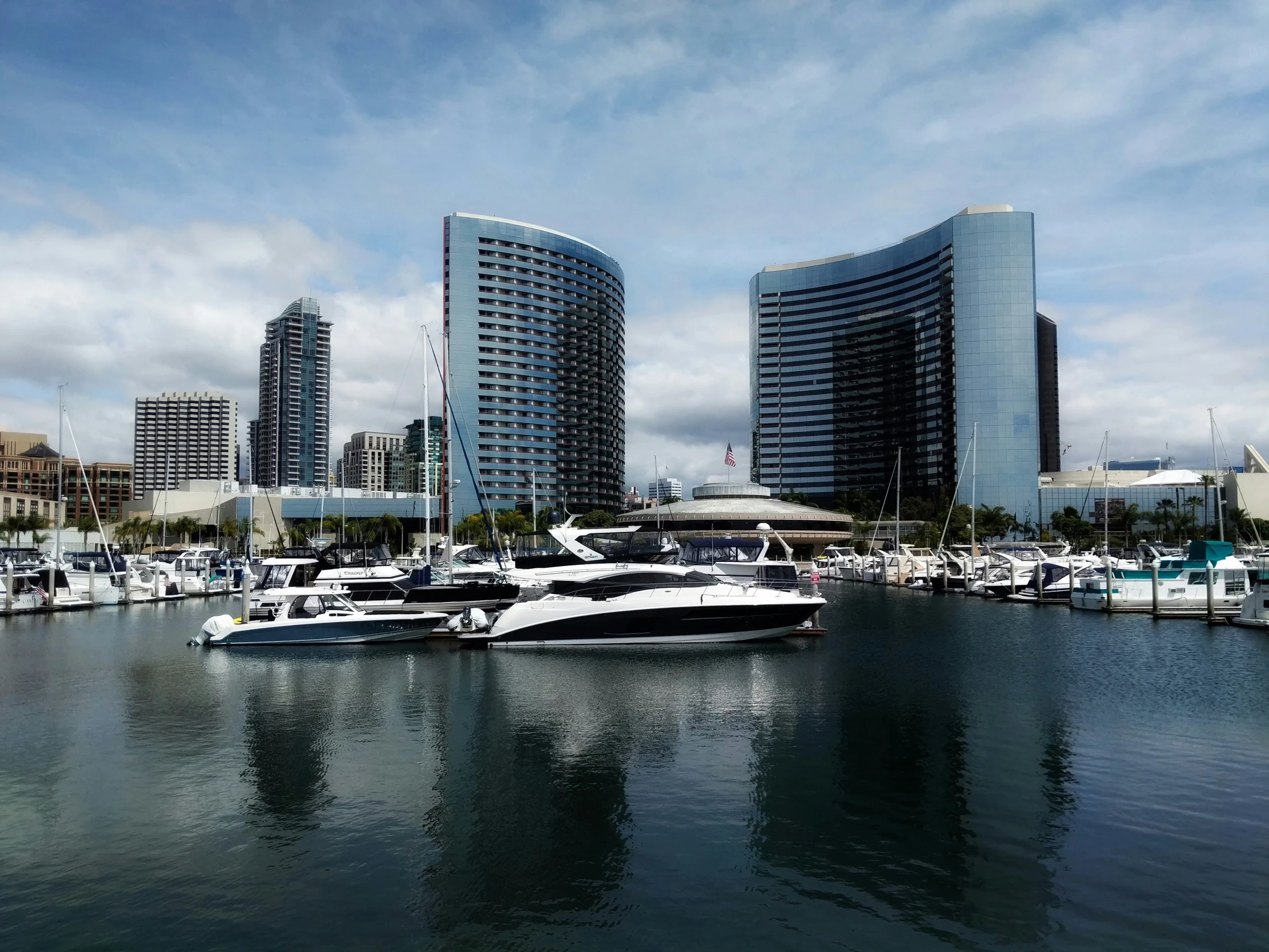 large body of water with boats parked in front of buildings