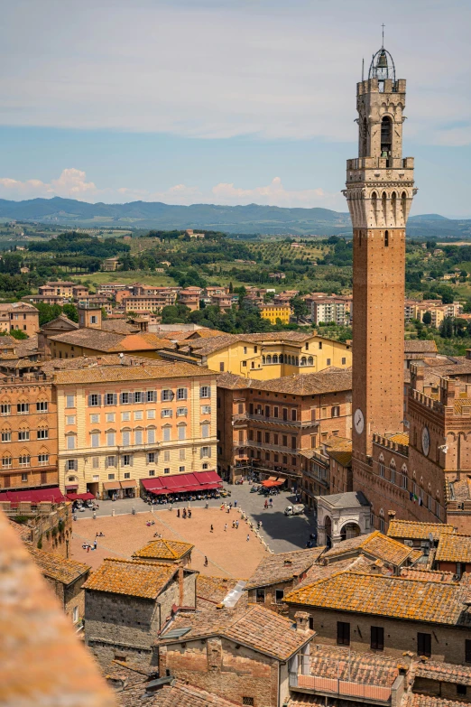 a tall clock tower sitting over a city with buildings