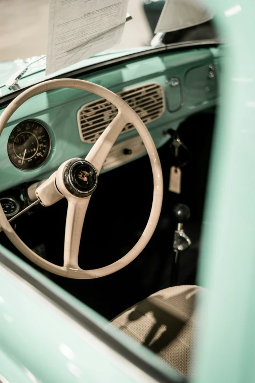 inside of an old, bright green car with white trim and steering wheel