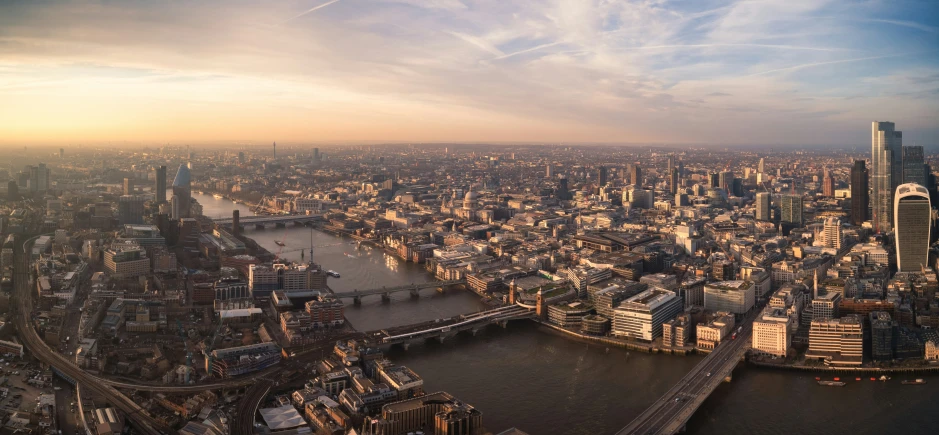 an aerial view of city buildings in a river running through it