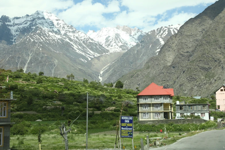 houses near the mountains with snow on them