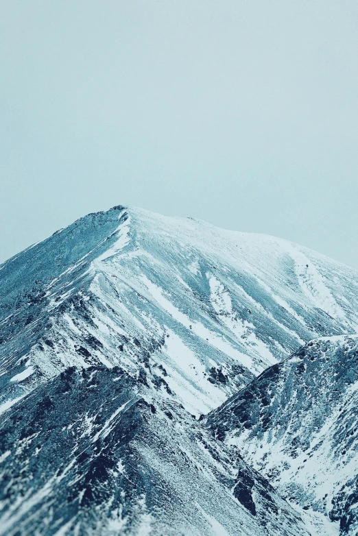 the mountains are covered in white snow