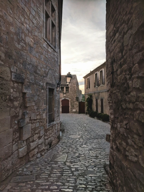 stone streets of old buildings line a cobblestone sidewalk