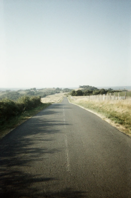 an empty country road in the middle of a plain