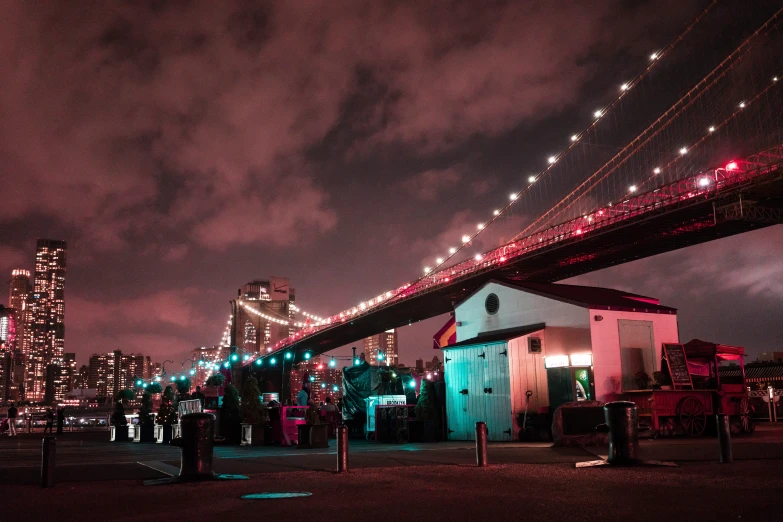 a suspension bridge in a city at night