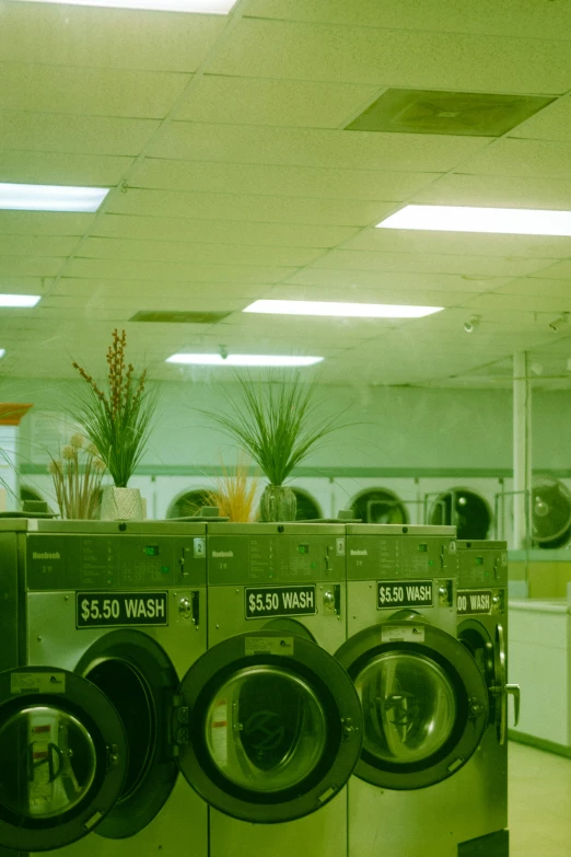 a bunch of washers in the laundry machines are stacked together