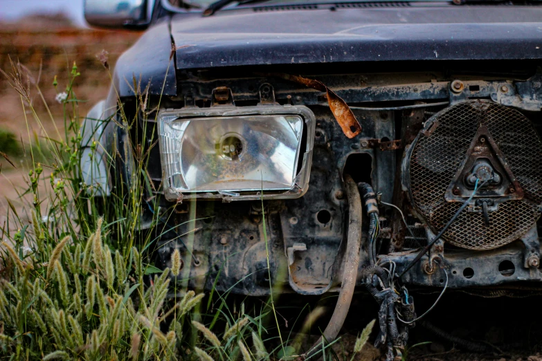 the front bumper of a car with an old metal grille and a worn down front