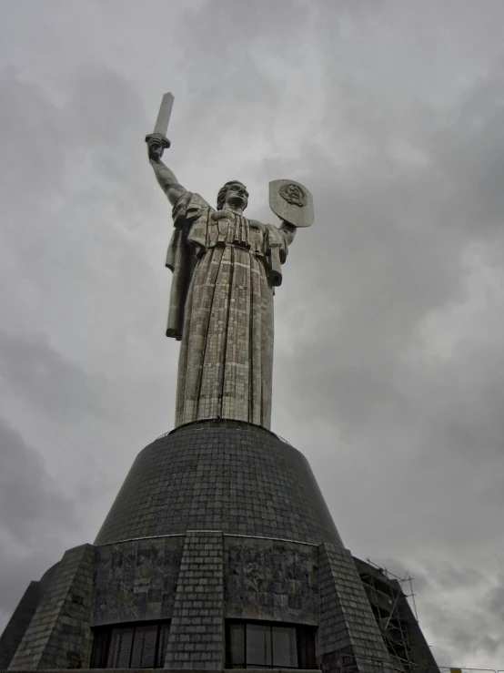 a statue is shown with many items on top