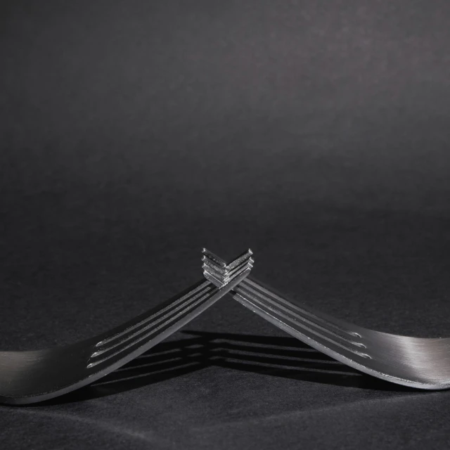 two forks with four forks sticking out of them