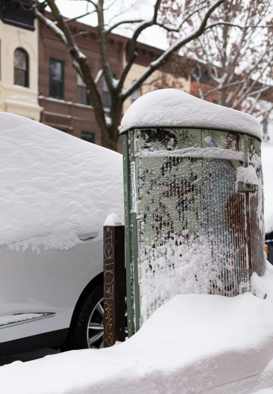 an old - fashioned white car is covered with snow