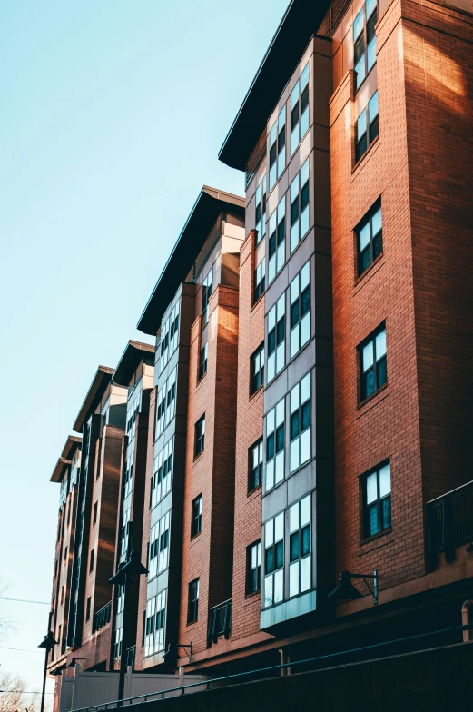 the large red brick building is situated close to other tall buildings