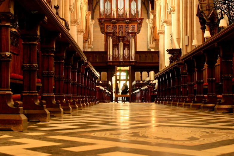 view of the hallway inside a cathedral with pillars and clocks