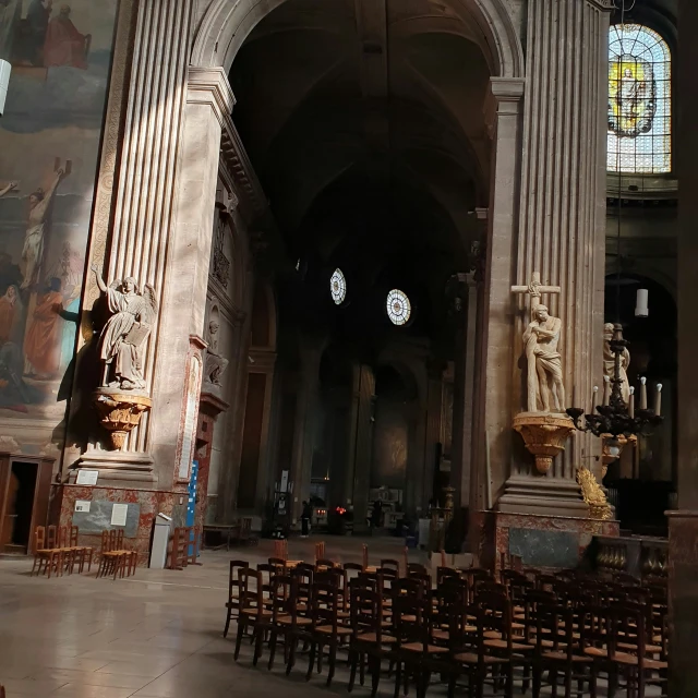 a large church with pillars, pillars and statues