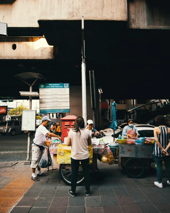 the people are at the food stand with their trucks