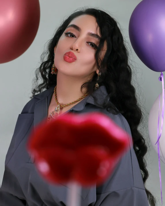 a close up of a woman standing next to balloons