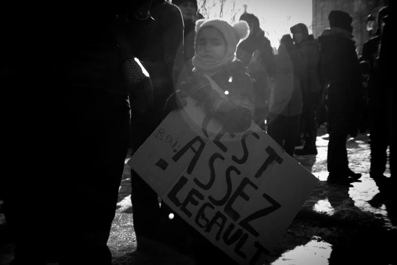 a woman holding a sign in the street