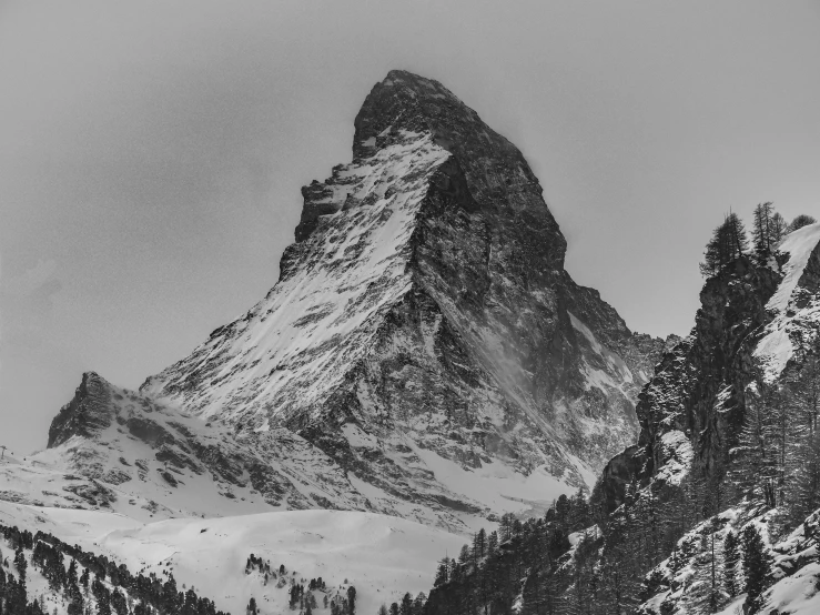 black and white pograph of mountains under gray skies