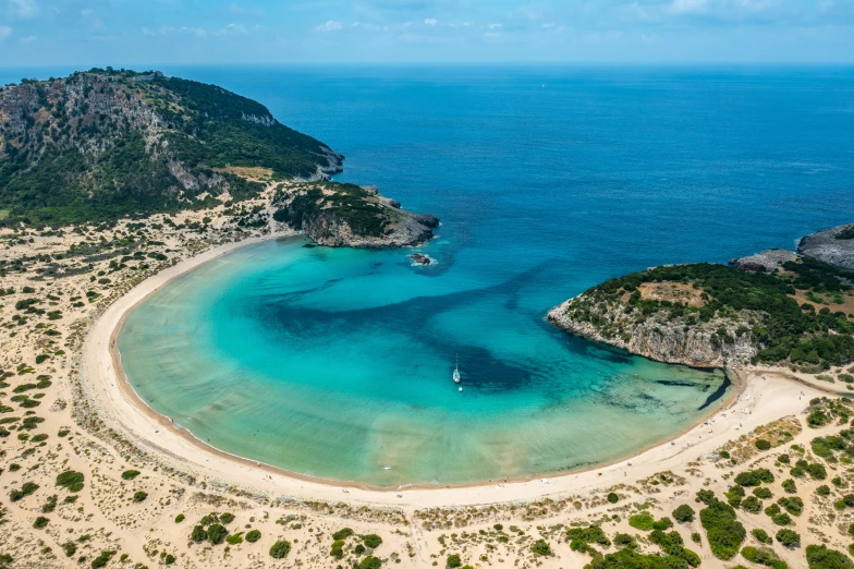 the water in the middle of a sandy beach