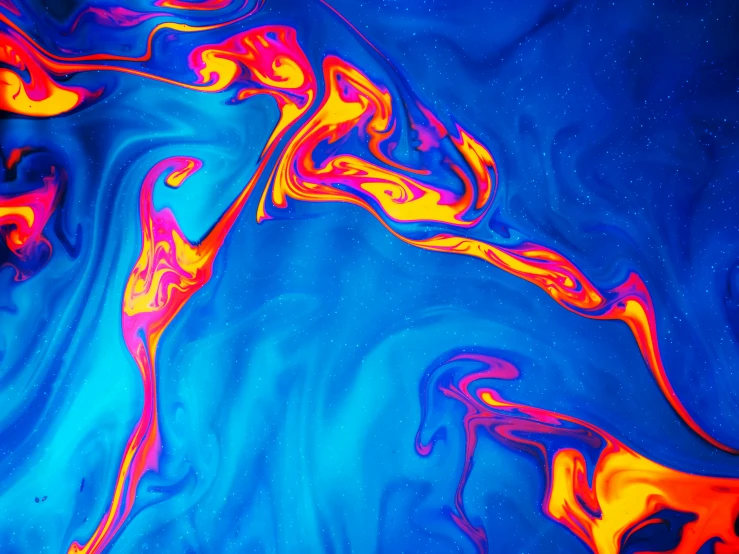 psychedelic patterns are formed over blue and yellow liquid