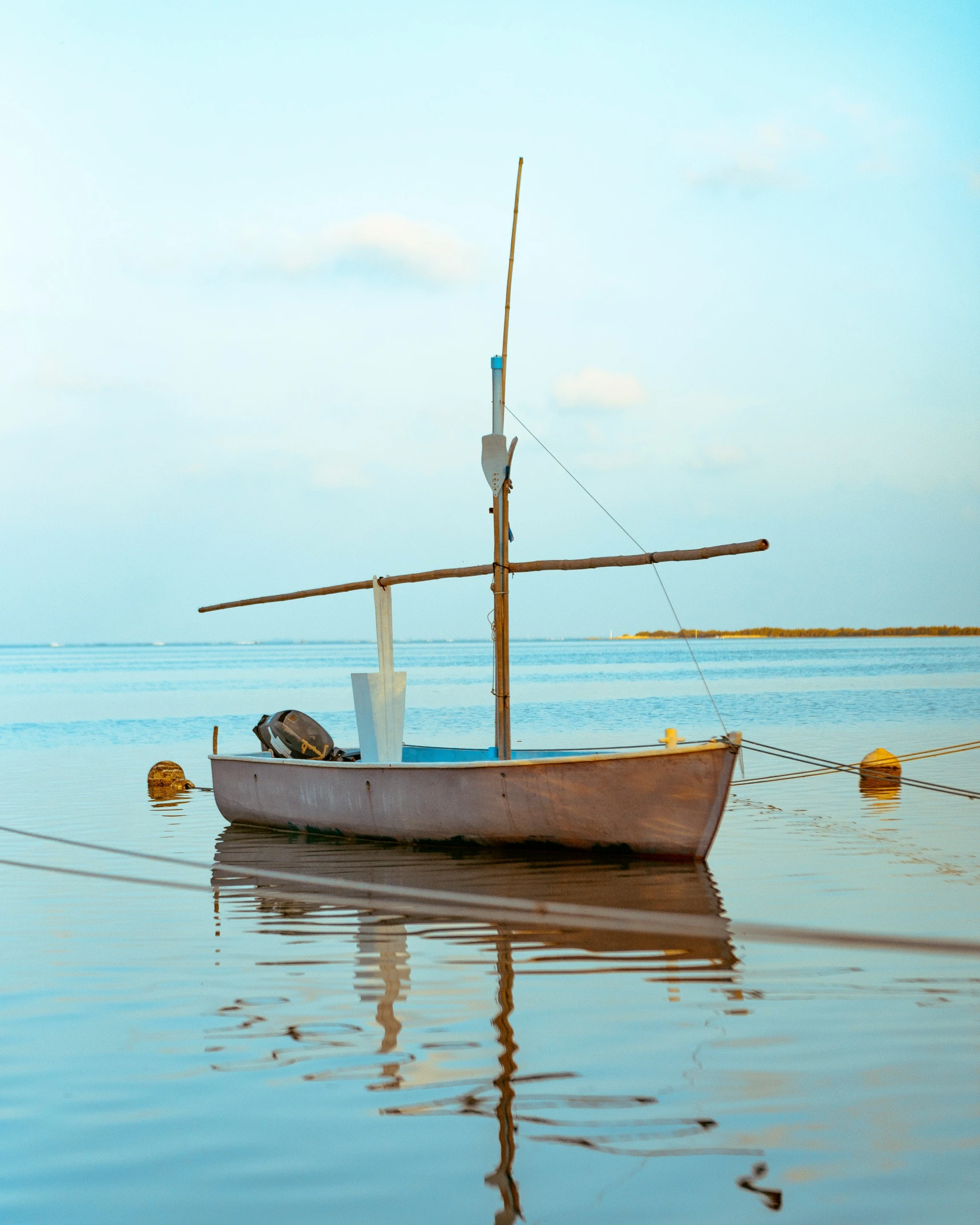 an old sailboat in the ocean still under repair