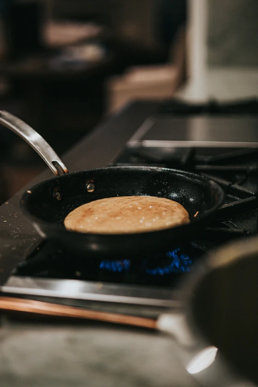 frying pan with pancake on stove top in kitchen