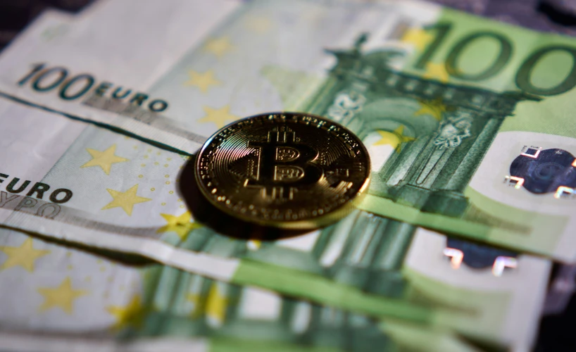 one euro coin on a 50 euros bill