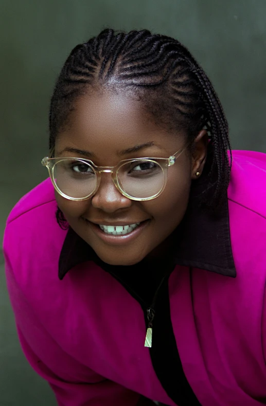 a girl with glasses poses for a picture