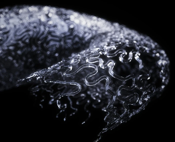 a close up of a black object with drops of water