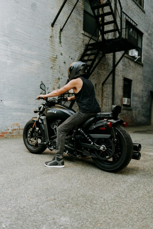 a young person sitting on a motor bike