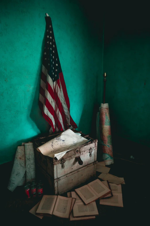 an american flag is hanging over a trunk on a pile of luggage