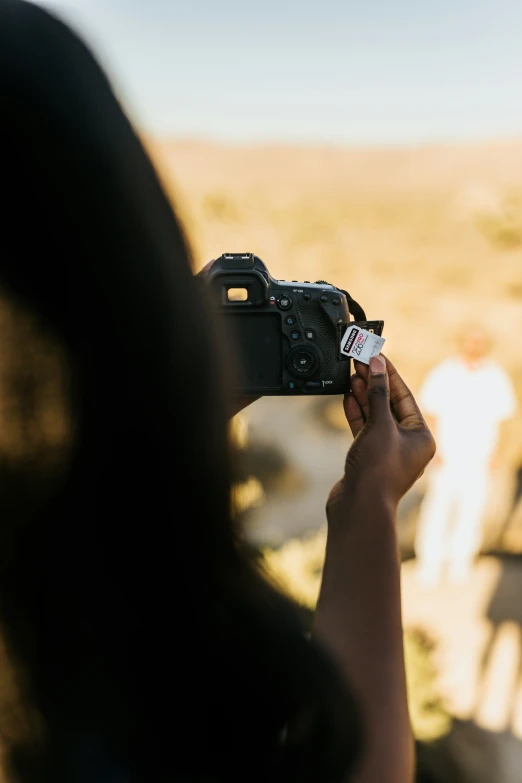 a woman takes a picture of an image with her digital camera