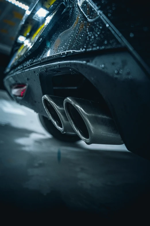 front end of a modern car on wet pavement