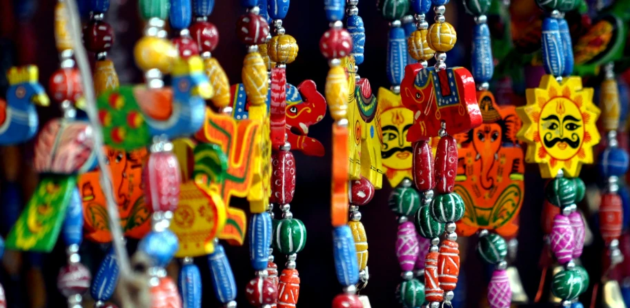 the colorful plastic objects are hanging on the strings