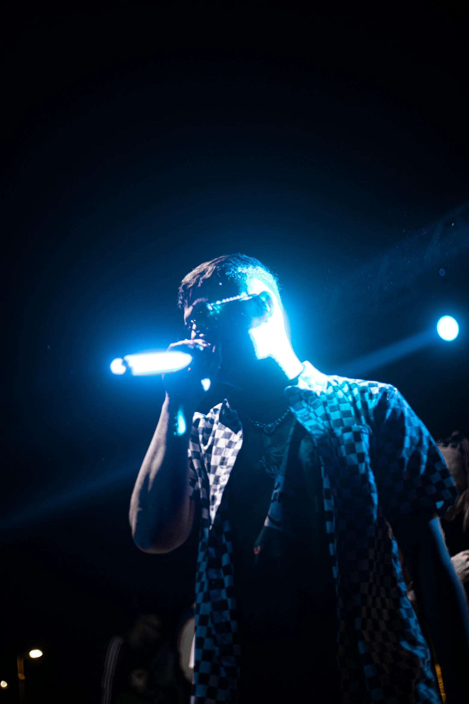 a man standing in front of some blue lights