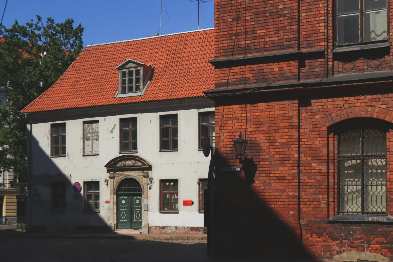 a large brick house is shown on the street