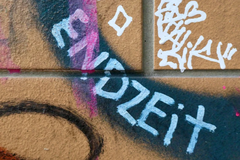 a brick wall with graffiti and writing on it