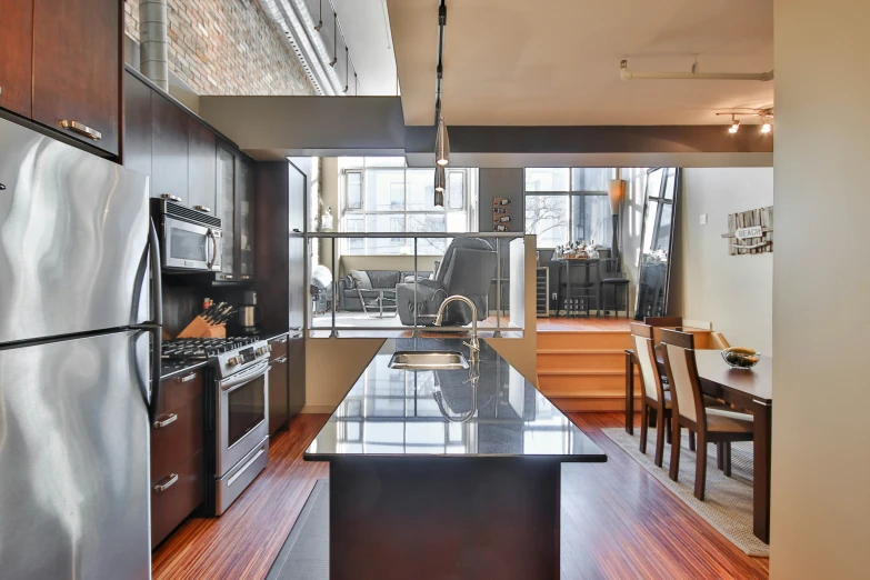 a clean and modern looking kitchen with wooden floors